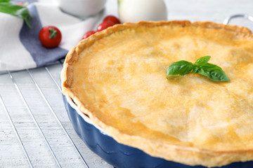 Delicious meat pie on baking grid, closeup
