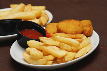 Chicken nuggets with french fries and ketchup