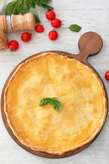 Board with delicious meat pie on table
