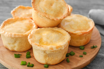 Delicious meat mini pies on board, closeup