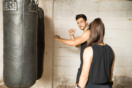 Male boxer giving advice to a woman - Powered by Adobe