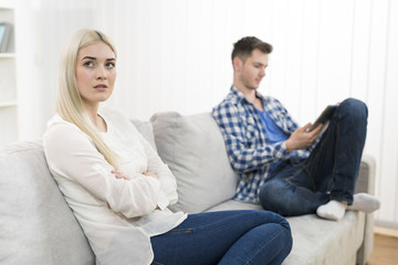 The sad woman sit near sad woman on the sofa