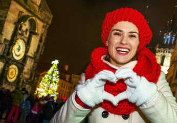 tourist woman at Christmas in Prague showing heart shaped hands