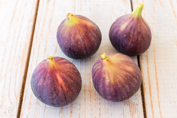 Portion of fresh figs on vintage wooden background.