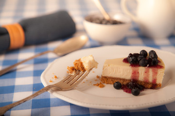 cheesecake on a plate with blueberries