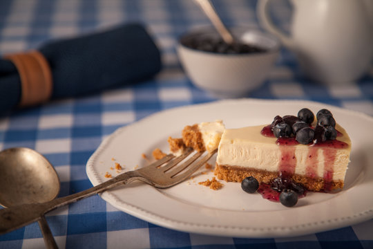 cheesecake on a plate with blueberries