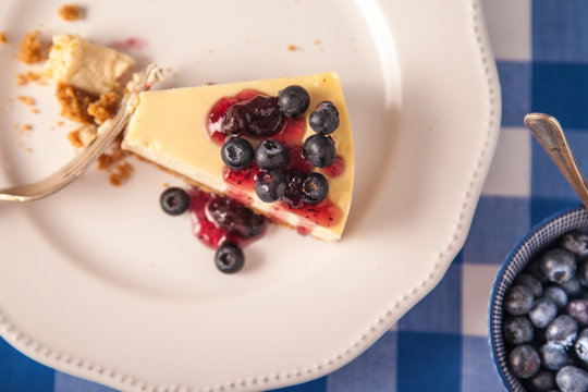 cheesecake on a plate with blueberries