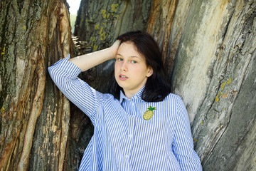 happy smiling girl lies on the grass in the park outdoor