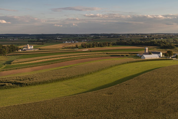 Aerial view of farmland with cloudy sky at sunset