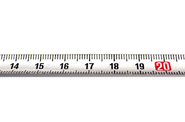 Detail of a metal ruler on white background pointing out number 20