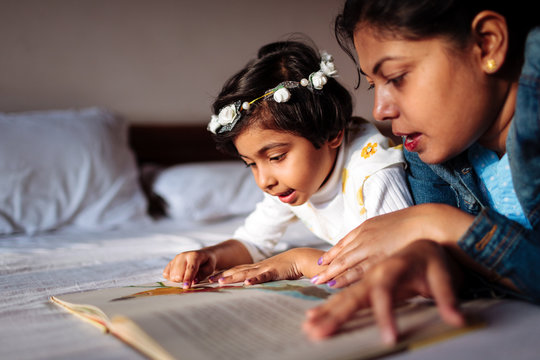 Mother reading a story to her daughter