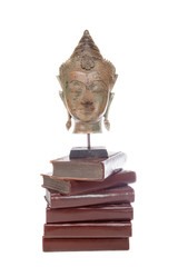 Philosophy ethics and religion. Statue of the philosopher Buddha on ancient teaching books.