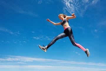Fototapeta na wymiar Female athlete remains in air while running