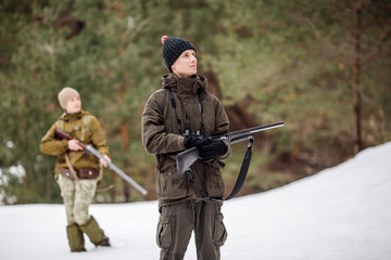 two hunters tracking prey and ready to hunt.