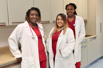 Three female healthcare workers. Young medical interns in hospital