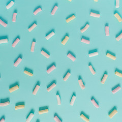 Fototapeta na wymiar Colorful marshmallow pattern on pastel blue background. Flat lay, top view minimal concept.