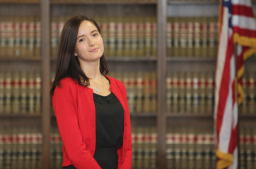 Portrait of a young female professional, woman lawyer in law library