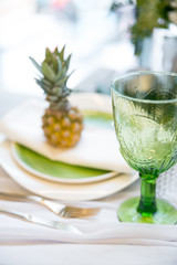 plate decorated with a pineapple, glass and decor, green and white colour