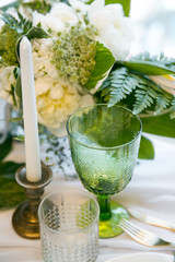 glass with candle and decor, green and white colour