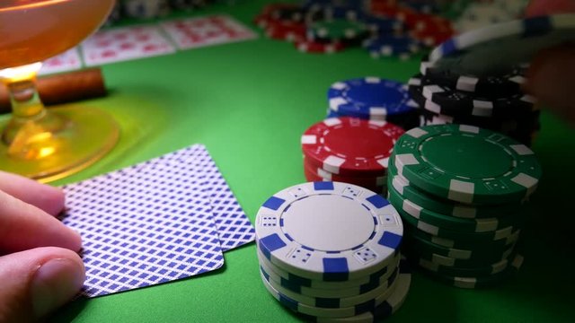 Gambling Poker Player Moves Chips on Table at Casino. Casino Chips, Aces And King. Winner In Poker. Poker Player Risk And Going All-in