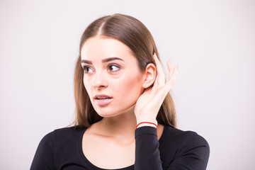 Young Girl listening with her hand on an ear