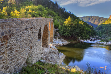 Fototapeta na wymiar old roman stone bridge near Ardino, Bulgaria