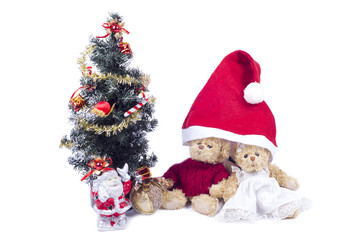 Fototapeta na wymiar Plush bear cubs near an artificial Christmas tree with Santa Claus