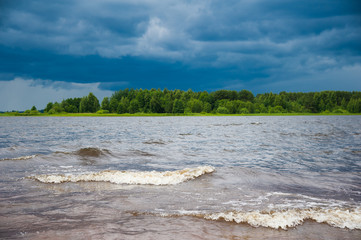 Dark gray cyan cloudy stormy sky over river