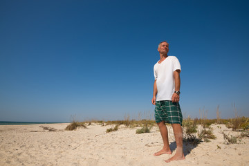 Happy man traveler on seaside