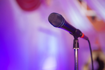 Microphone. A microphone on stage. A pub. Bar. Restaurant. Classic. Evening. Night show. European restaurant. European bar. American restaurant. American bar.
