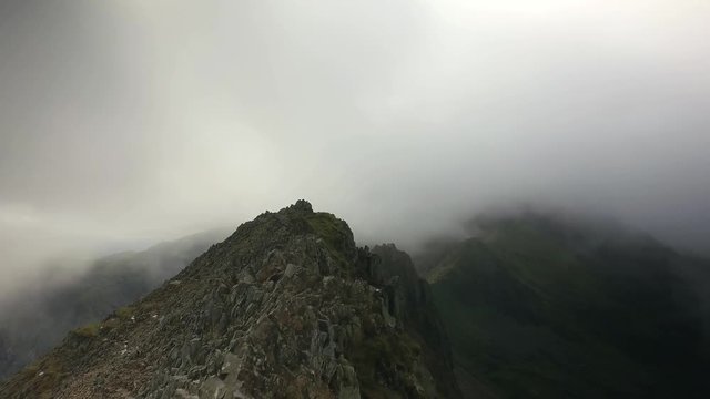 Walking Crib Goch mountain ridge in Snowdonia, Wales, UK.