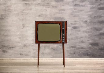 Retro TV on grunge wall background
