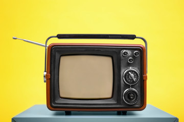 Old vintage TV on color background