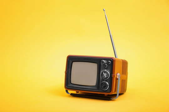 Old vintage TV on color background
