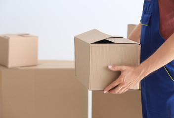 Delivery man holding box, closeup