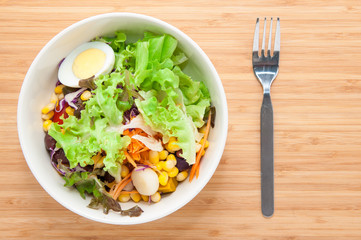 Fresh healthy salad on table.