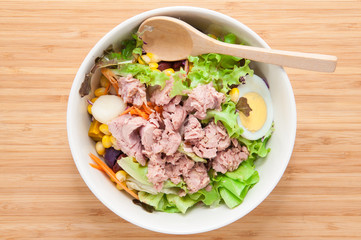 Tuna salad on wooden table.