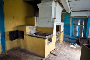Interior of an abandoned Russian rural house, Russian stove.
