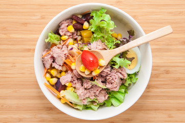 Tuna salad on wooden table.