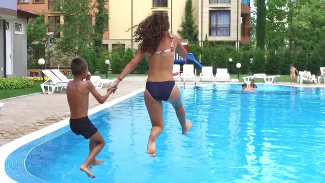 Girl and Boy jump in pool SLOW MOTION