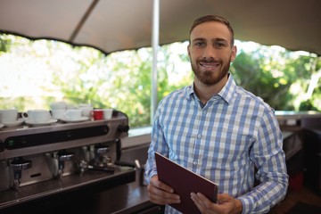 Smiling manager holding clipboard