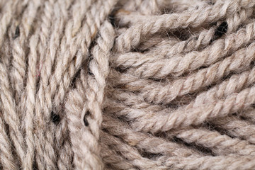 A super close up image of tan yarn