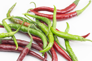 Red and green chilli peppers on the white background