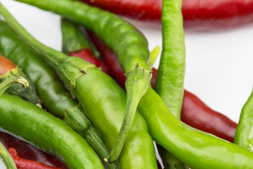 Red and green chilli peppers on the white background