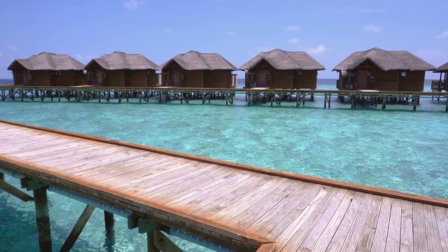 Tropical travel card with water bungalows at maldivian island