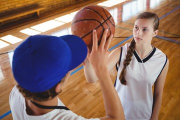 High angle view of male coach training female basketball player - Powered by Adobe