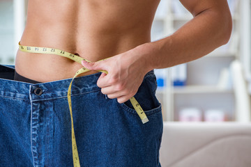 Man in oversized pants in weight loss concept