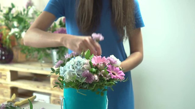 Florist for making a hat box with flowers in a flower shop close-up 4k.