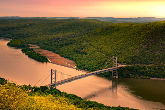 Aerial view of Bear Mountain Bridge at sunrise. Bear Mountain Bridge is a toll suspension bridge in New York State, carrying U.S. Highways 202 and 6 across the Hudson River