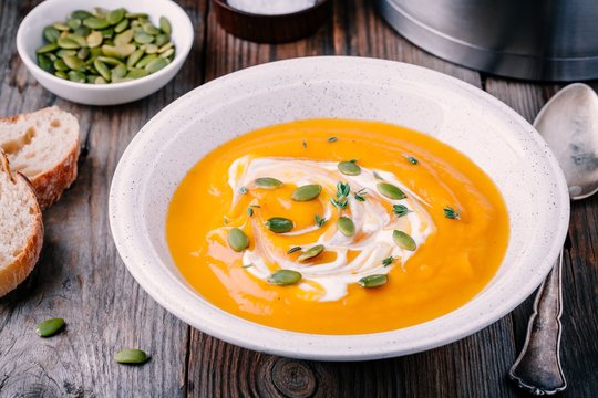 Homemade pumpkin soup with cream and seeds